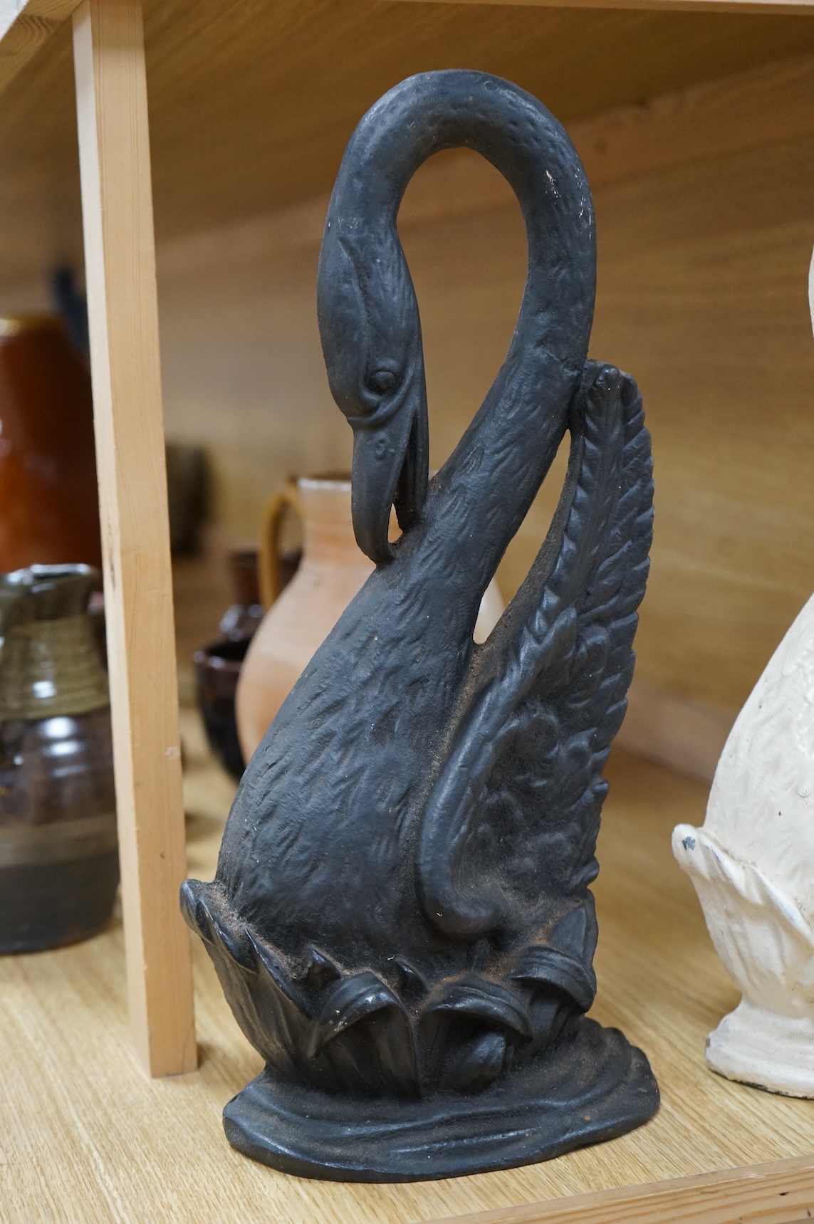 Two Victorian cast iron ‘swan’ door stops, one painted, 38cm